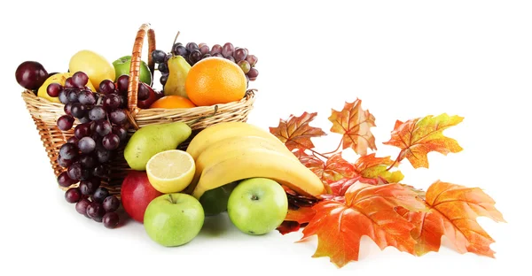 Composition of different fruits with basket and yellow leaves isolated on white Stock Photo