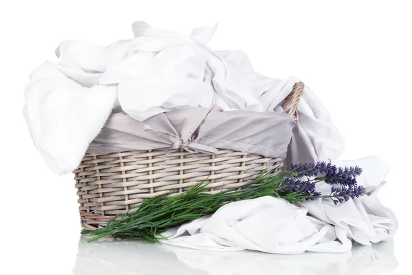 Rumpled bedding sheets in wicker basket isolated on white — Stock Photo, Image