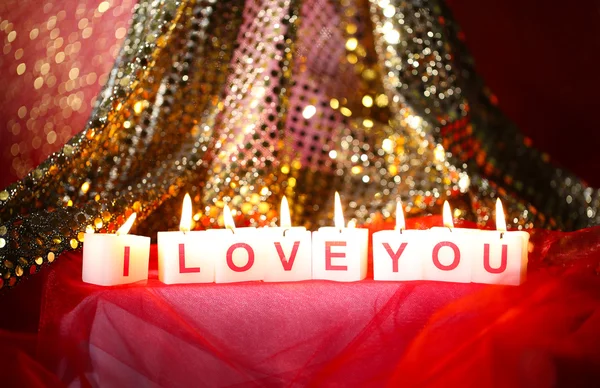 Candles with printed sign I LOVE YOU, on blur lights background — стоковое фото