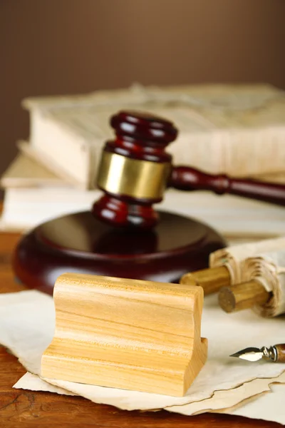 Wooden stamp, gavel and old papers on wooden table — Stock Photo, Image