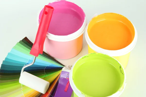 Set for painting: paint pots, paint-roller and palette of colors isolated on white — Stock Photo, Image