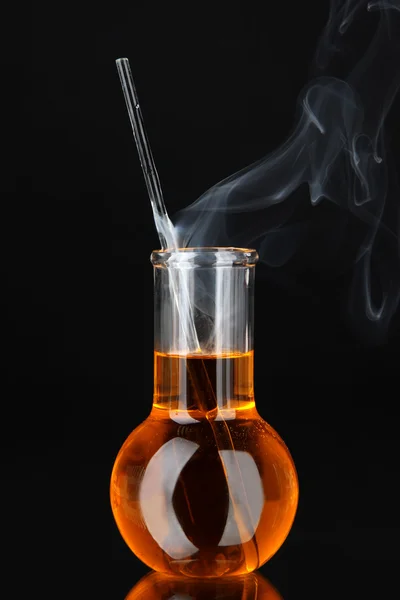 Laboratory beaker on black background — Stock Photo, Image