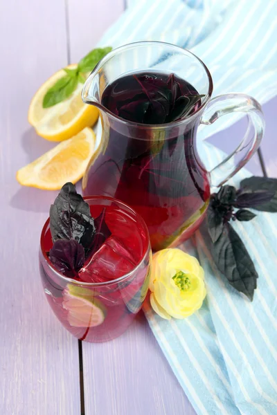 Red basil lemonade in jug and glass, on wooden background — Stock Photo, Image