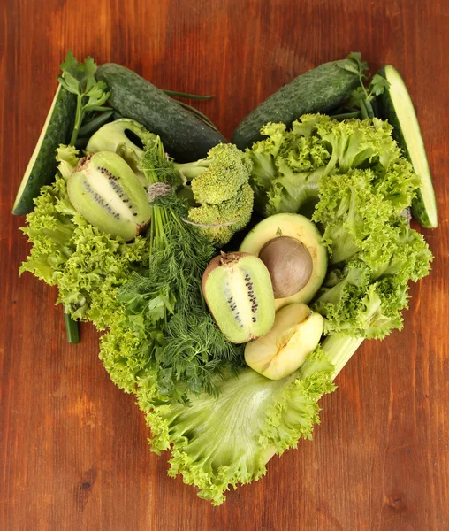 Fresh green vegetables and fruits, on wooden background — Stock Photo, Image