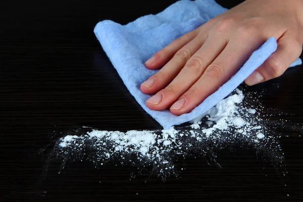 Hand wiping wooden surface with blue rag — Stock Photo, Image