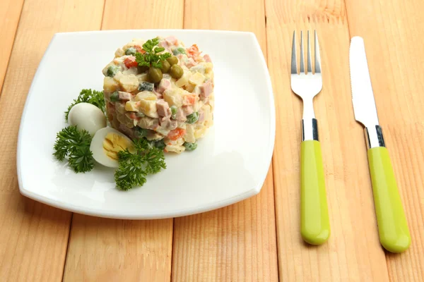 Russian traditional salad Olivier, on wooden background — Stock Photo, Image