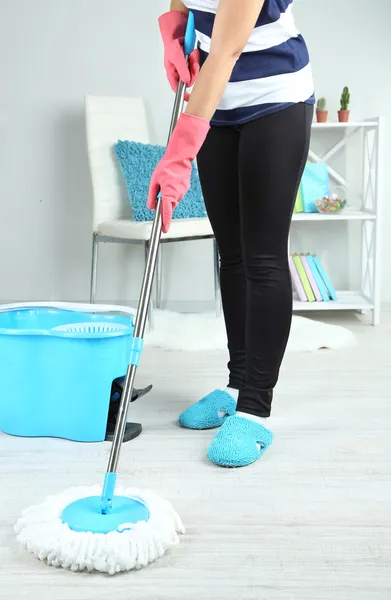 Mopping floor at home close-up