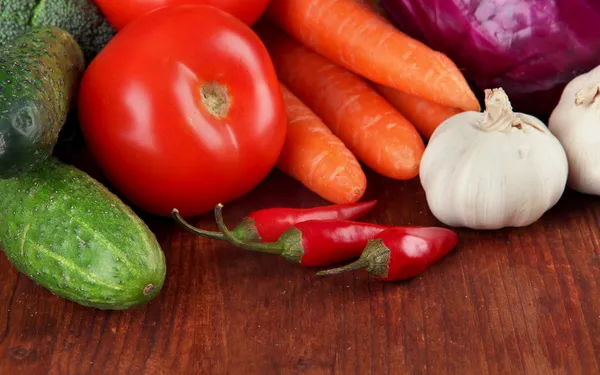Composition of different vegetables on wooden background — Stock Photo, Image