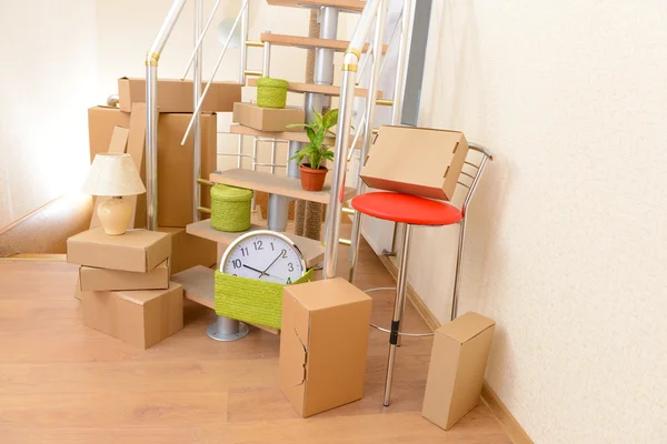 Stack of cartons near stairs: moving house concept — Stock Photo, Image