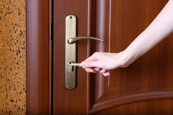 Locking up or unlocking door with key in hand — Stock Photo, Image