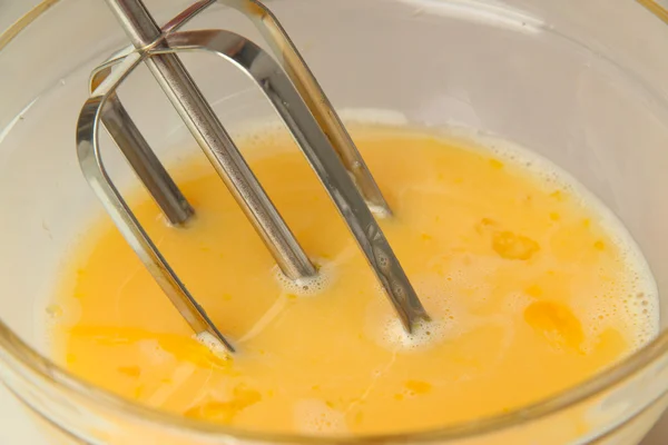 Cooking, whipping eggs with electric whisk in bowl, close up — Stock Photo, Image