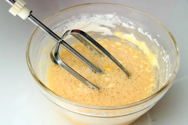 Cooking, whipping eggs with electric whisk in bowl, close up — Stock Photo, Image