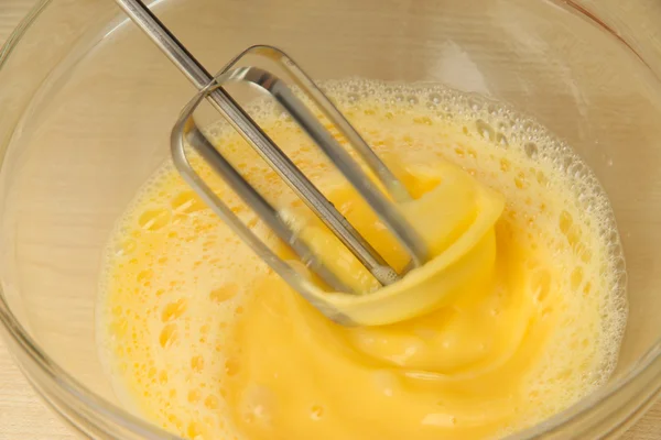 Cooking, whipping eggs with electric whisk in bowl, close up — Stock Photo, Image