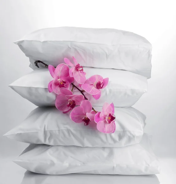 Pillows and flower, on grey background — Stock Photo, Image