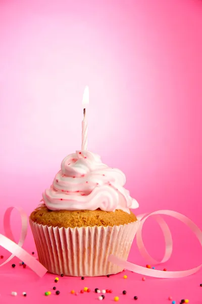 Tasty birthday cupcake with candle, on pink background — Stock Photo, Image