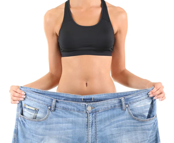 Menina magro com jeans grandes isolado no branco — Fotografia de Stock