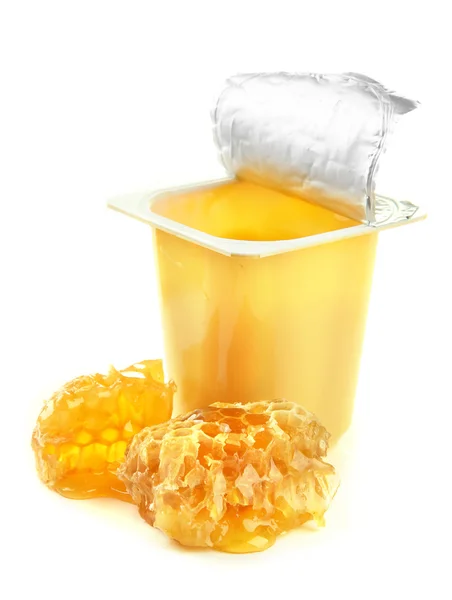 Tasty dessert in open plastic cup and honey combs, isolated on white — Stock Photo, Image