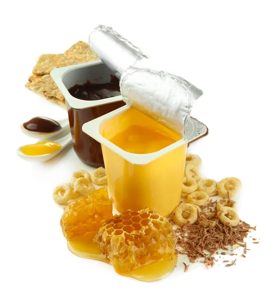 Tasty desserts in open plastic cups and honey combs, isolated on white — Stock Photo, Image