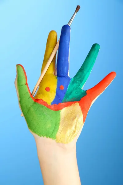 Painted hand with smile on blue background — Stock Photo, Image