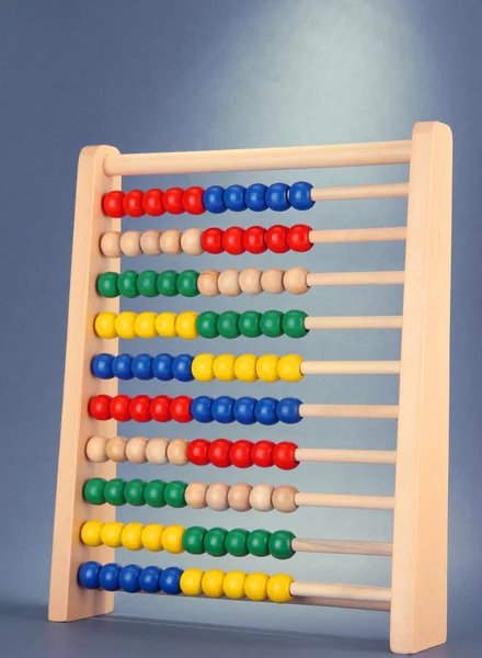 Bright wooden toy abacus, on grey background — Stock Photo, Image