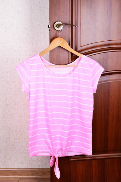 T-shirt hanging on door — Stock Photo, Image