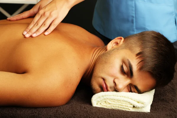 Young man having back massage close up — Stock Photo, Image