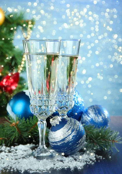 Composition with Christmas decorations and two champagne glasses, on bright background — Stock Photo, Image