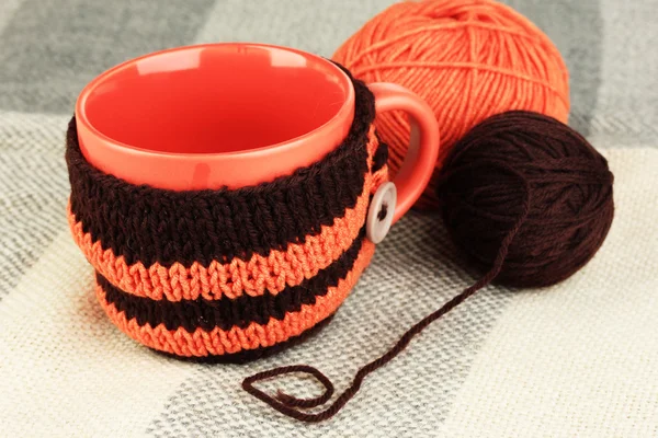 Cup with knitted thing on it close up — Stock Photo, Image