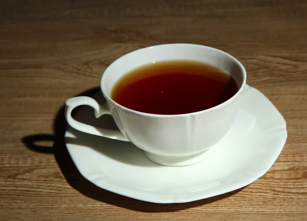 Cup of hot beverage on wooden table — Stock Photo, Image