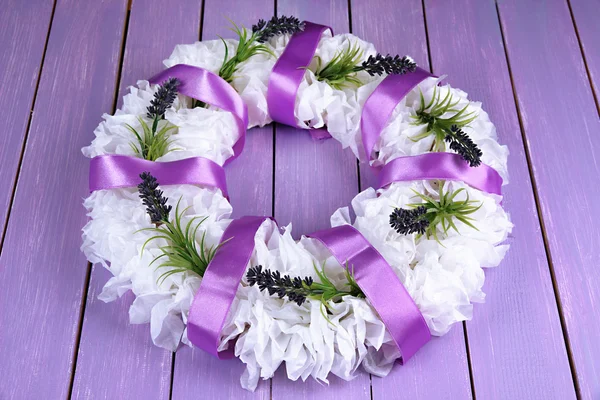 Decorative wreath with flowers on wooden background — Stock Photo, Image
