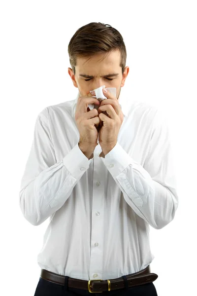 Sneezing young man isolated on white — Stock Photo, Image