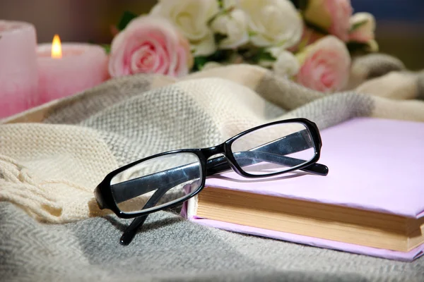 Composition with old book, eye glasses, candles and plaid on dark background — Stock Photo, Image