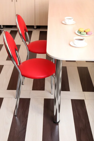 Moderne rote Stühle am Tisch in der Küche — Stockfoto