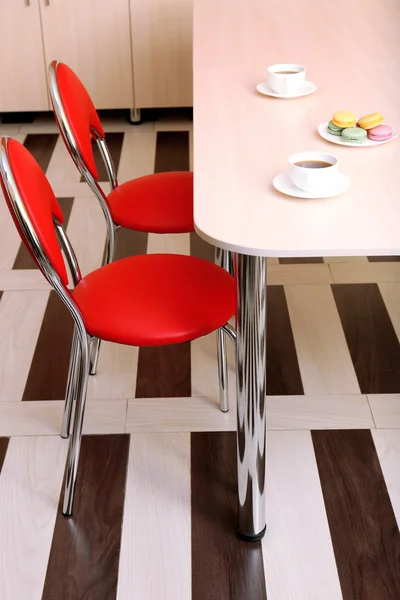 Modern red chairs near table in kitchen — Stock Photo, Image