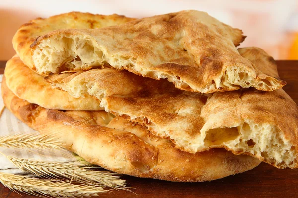 Pita breads with spikes on table on bright background — Stock Photo, Image