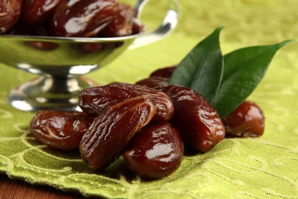 Dried dates in metal dish on fabric background — Stock Photo, Image