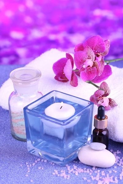 Beautiful spa setting with orchid on purple background — Stock Photo, Image