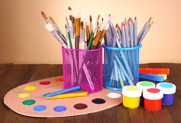 Composition of various creative tools on table on beige background — Stock Photo, Image