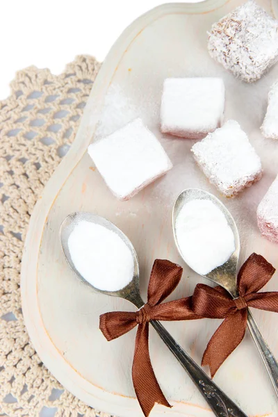 Tasty oriental sweets (Turkish delight) with powdered sugar, on wooden desk — Stock Photo, Image