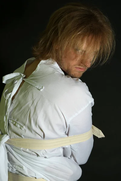 Mentally ill man in strait-jacket on black background — Stock Photo, Image