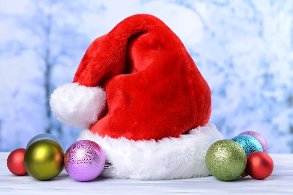 Composition with Santa Claus red hat and Christmas decorations on light background — Stock Photo, Image