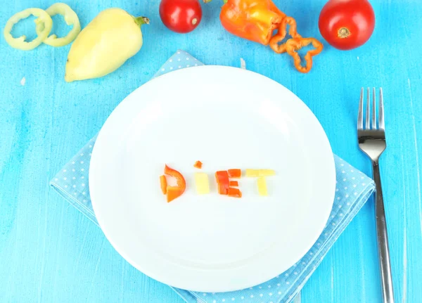 Small portion of food on big plate on wooden table close-up — Stock Photo, Image