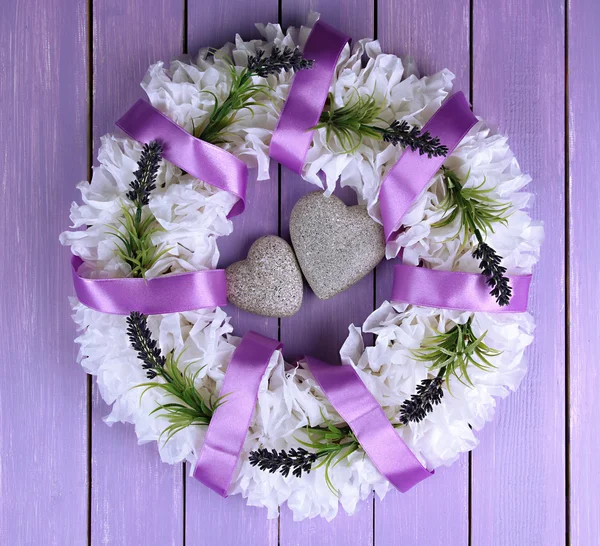 Decorative wreath with hearts on wooden background — Stock Photo, Image