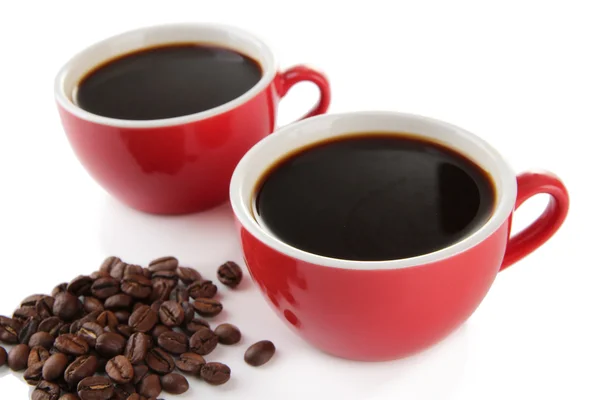 Red cups of strong coffee and coffee beans close up — Stock Photo, Image