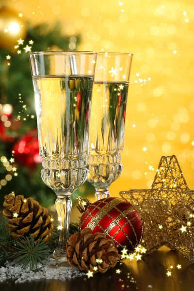 Composition with Christmas decorations and two champagne glasses, on bright background — Stock Photo, Image