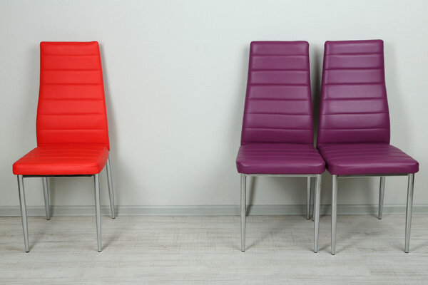 Modern color chairs on wall background