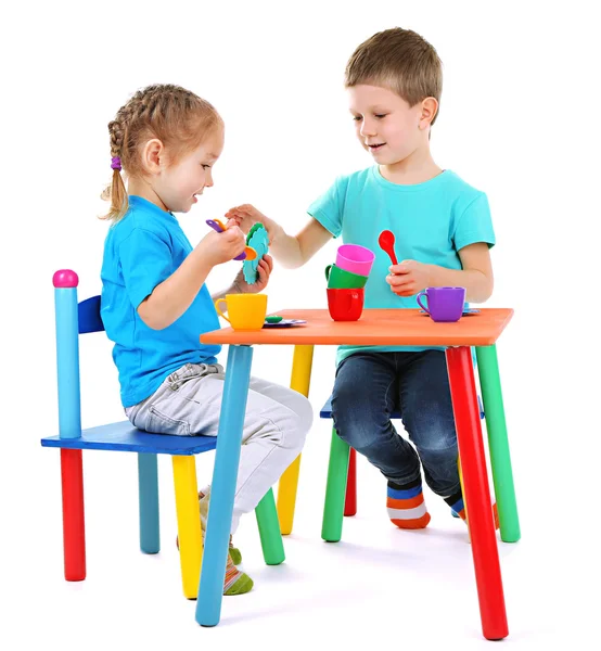 Little children playing with colorful tableware — Stock Photo, Image