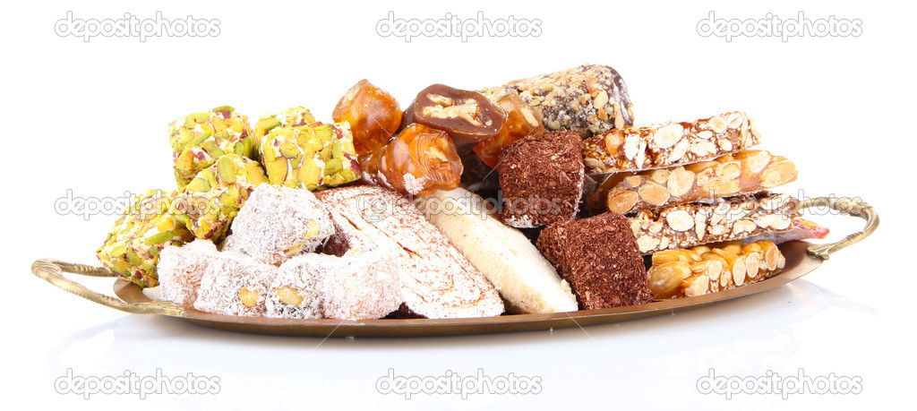 Tasty oriental sweets on metal tray, isolated on white