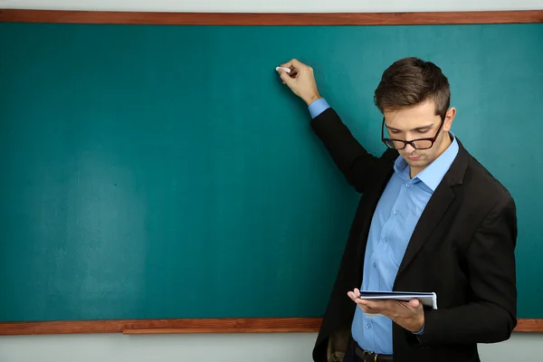 Teacher near chalkboard — Stock Photo, Image