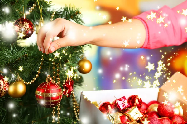 Decorating Christmas tree on bright background — Stock Photo, Image